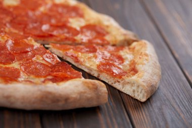 tasty pizza on wooden background, close-up 
