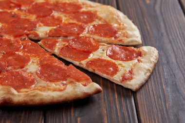 tasty pizza on wooden background, close-up 
