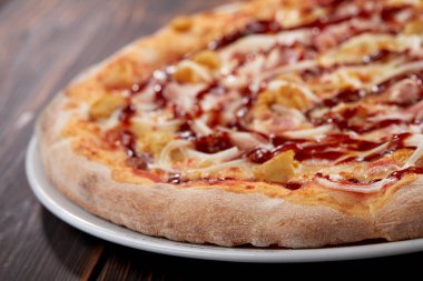 tasty pizza on wooden background, close-up 