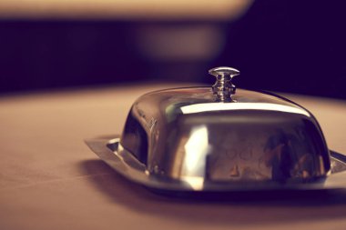 Gümüş tereyağı çanak üzerinde ahşap masa, yakın çekim