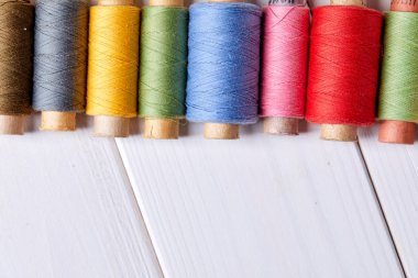 Ahşap arka planda iplik olan bobinler, yakın görüş