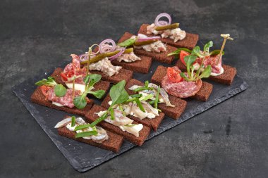 Et ve sebzeli kanepe koyu taş tahtada, yakın görüş  