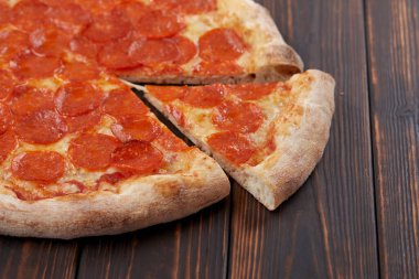 tasty pizza on wooden background, close-up 
