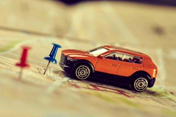 small toy car on map, travel concept