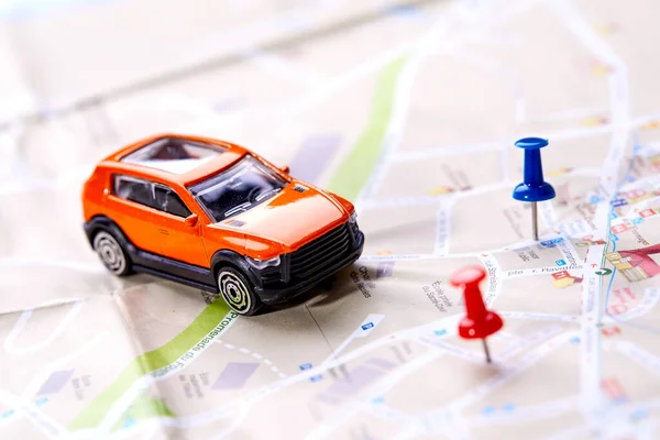 small toy car on map, travel concept