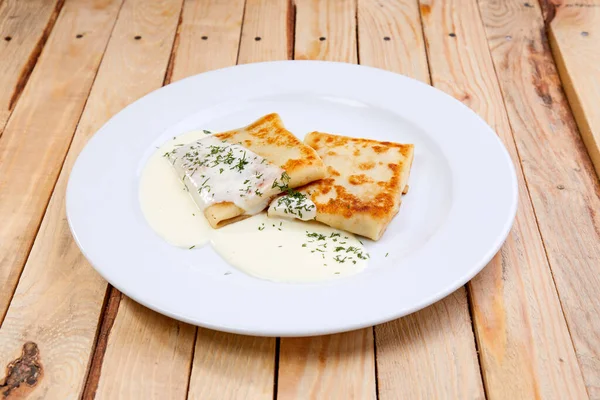 stock image stuffed pancakes with sour cream on white plate, close view 