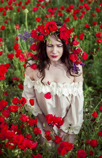 The girl poses on a poppy field — Stock Photo, Image