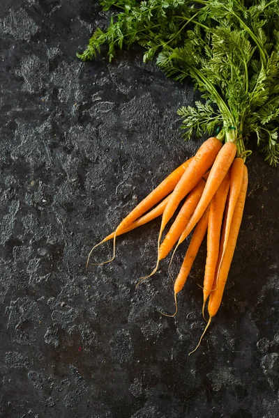 Fresh carrots on a black background — Stock Photo, Image