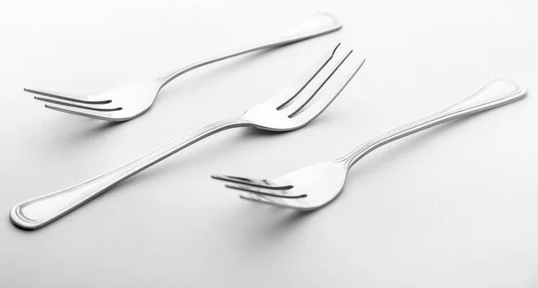 Tres tenedores aislados en blanco Imagen de stock