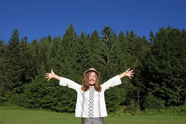 Cheerful little girl with hands up enjoy in nature — Stock Photo, Image