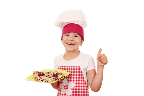 Happy little girl cook with crepes and thumb up — Stock Photo, Image