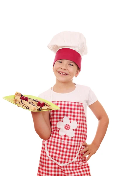Happy little girl cook with crepes on plate — Stock Photo, Image
