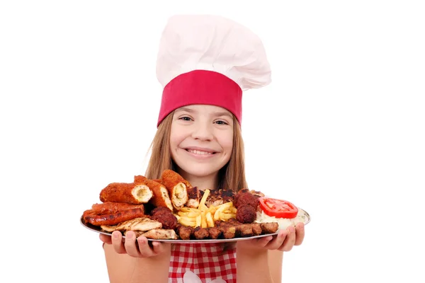 Happy little girl cook with grilled meat on plate — Stock Photo, Image