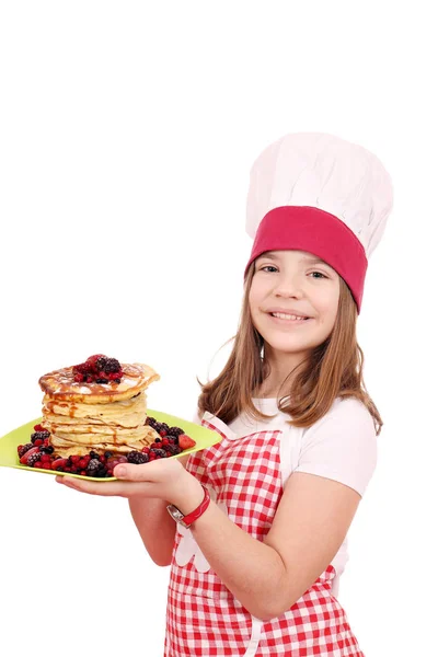 Happy little girl cook with pancakes on plate — Stock Photo, Image