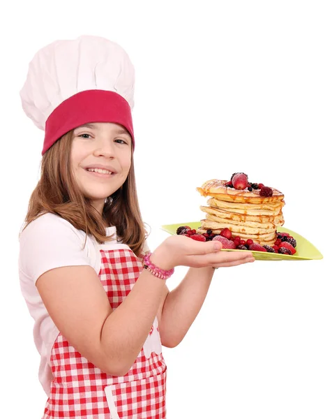 Felice cuoca bambina con dolci frittelle — Foto Stock