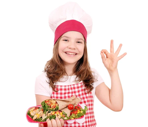 Happy little girl cook with burritos and ok hand sign — Stock Photo, Image