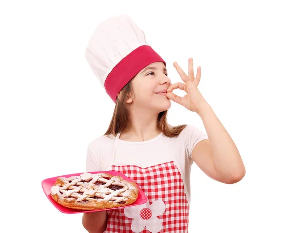 Happy little girl cook with cherry pie and ok hand sign — Stock Photo, Image