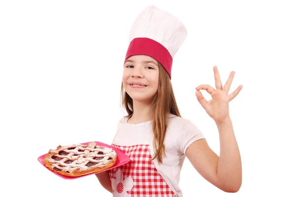 Niña cocinera con pastel de cereza y signo de mano ok — Foto de Stock