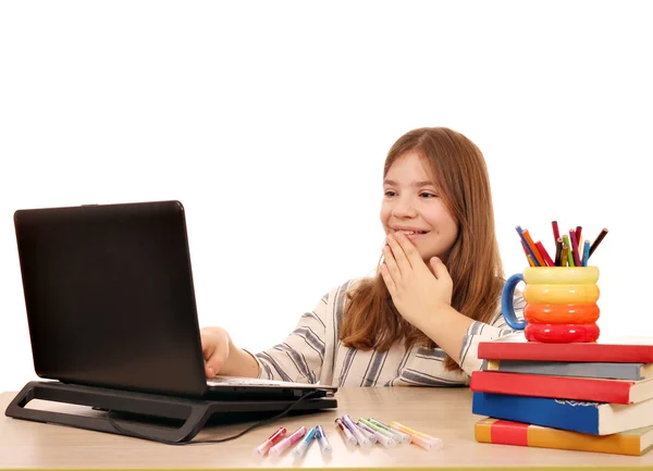 Little girl looks at something fun on the laptop — Stock Photo, Image