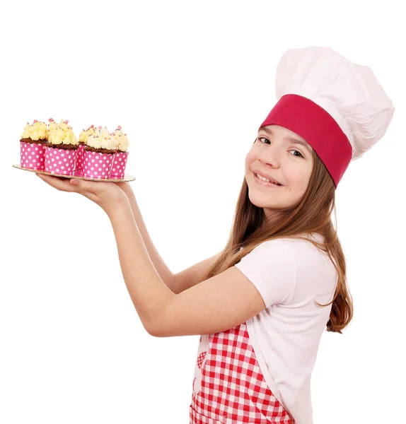 Menina feliz cozinhar com muffins — Fotografia de Stock