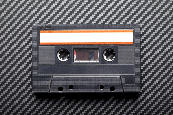 Old cassette tape on carbon background — Stock Photo, Image