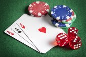 Hrát karty, pokerové žetony a kostky na zeleném stole