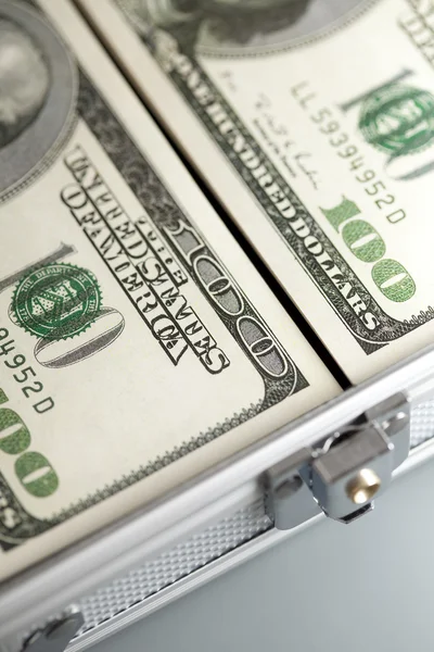 Metallic business suitcase and dollar bills — Stock Photo, Image