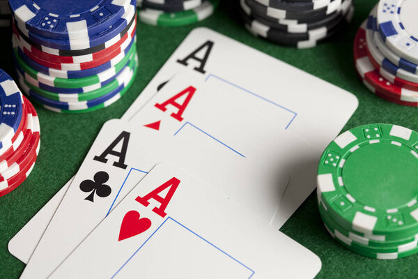 Playing cards and poker chips on green table