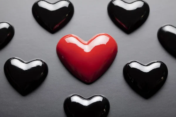 Red and black hearts on black background