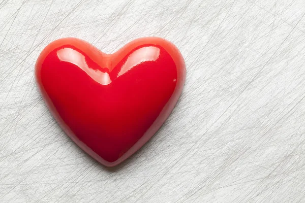 Red heart on scratched surface background — Stock Photo, Image