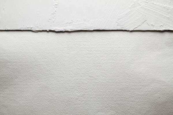 White plaster on the wall and handmade paper sheet background or