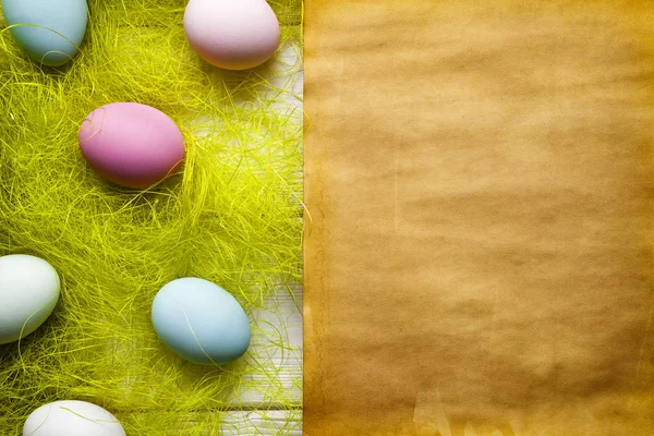Påsk bakgrund - tom handgjort papper plåt och färgade ägg — Stockfoto