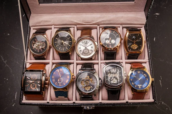 storage black leather box with collection of men wrist watches