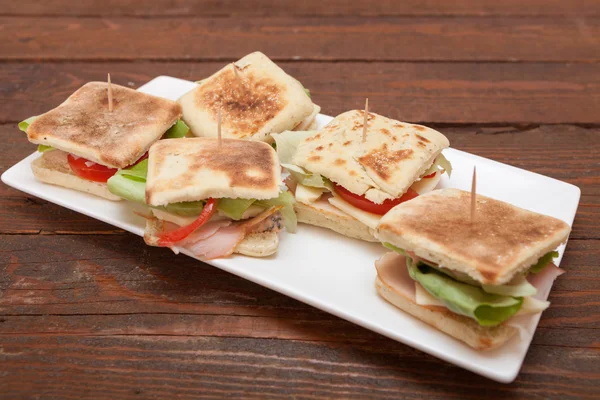 Small sandwiches with salmon, cheese and vegetables