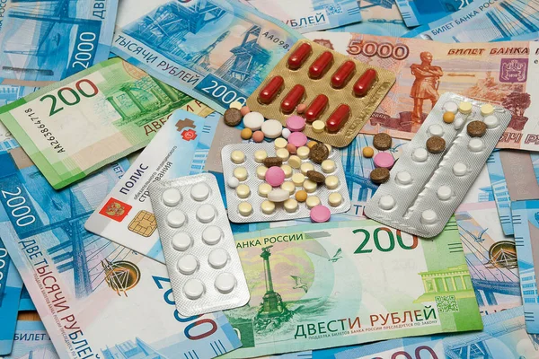 Pills, compulsory health insurance policy and banknotes of the Bank of Russia