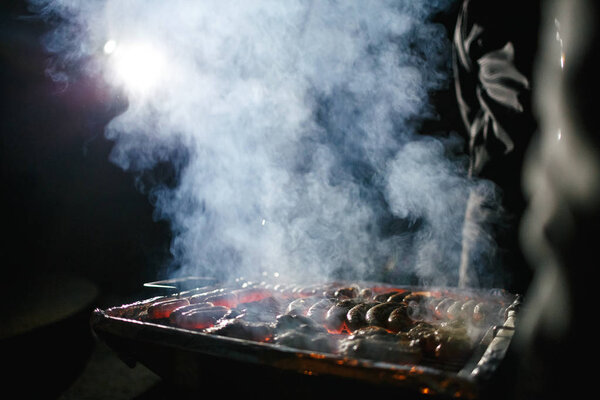 meat and sausages on the grill on the grill