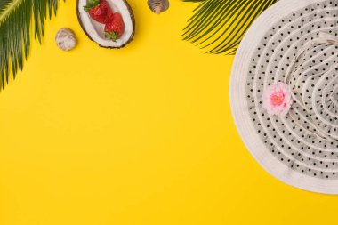 Summer composition with beach accessories, on yellow background. Top view, copy space. Flat lay.
