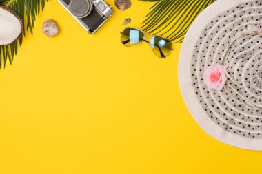 Summer composition with beach accessories, on yellow background. Top view, copy space. Flat lay.