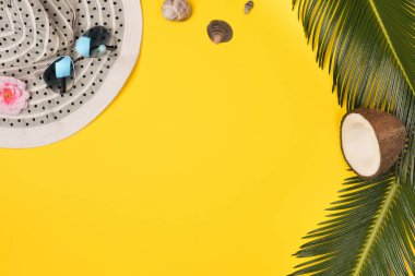 Summer composition with beach accessories, on yellow background. Top view, copy space. Flat lay.
