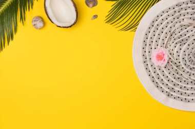 Summer composition with beach accessories, on yellow background. Top view, copy space. Flat lay.