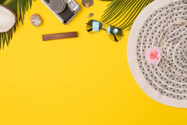 Summer composition with beach accessories, on yellow background. Top view, copy space. Flat lay.