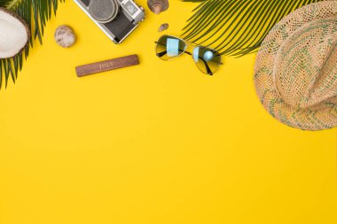 Summer composition with beach accessories, on yellow background. Top view, copy space. Flat lay.