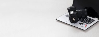 Modern digital DSLR camera and computer workstation. Photography and videography concept.