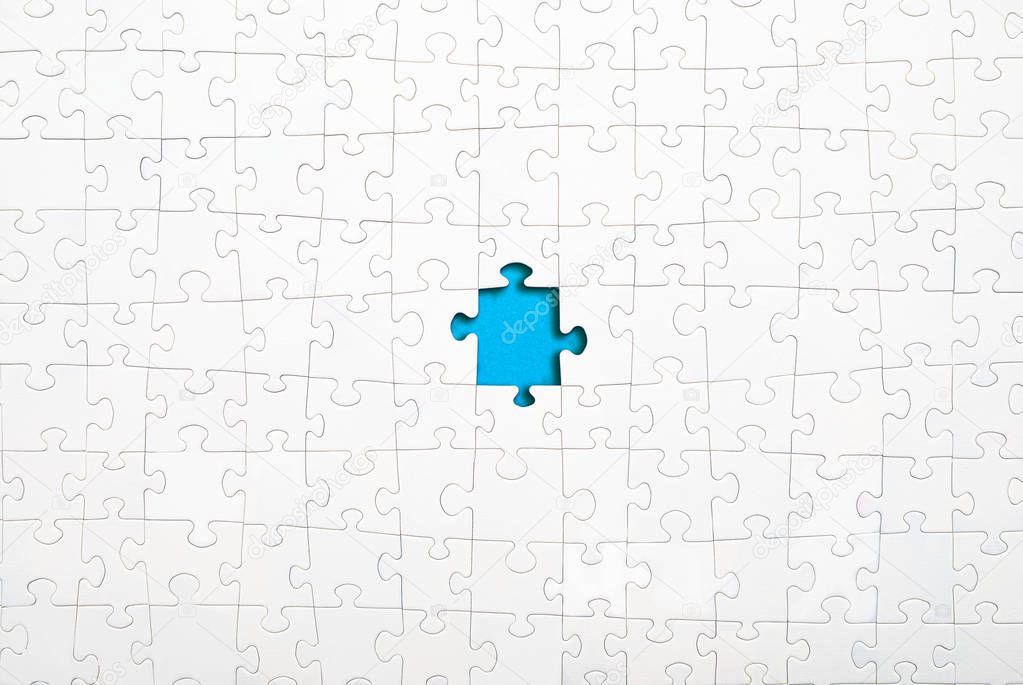 Missing white jigsaw puzzle pieces on blue background copy space for your text. Business concept. 