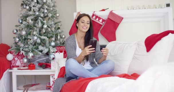 Young woman checking for Christmas messages — Stock Video