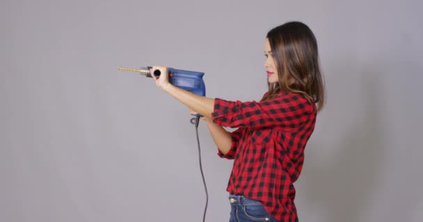 Capable attractive young woman holding a drill — Stock Video