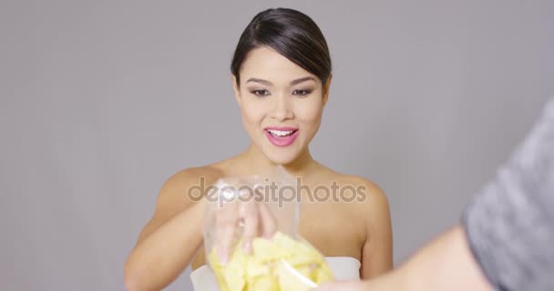 Happy woman grabbing potato crisps — Stock Video