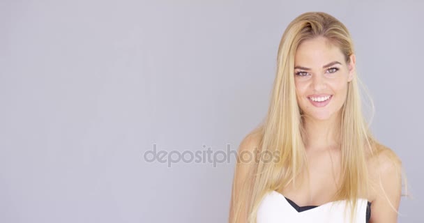 Happy attractive blond woman over gray — Stock Video