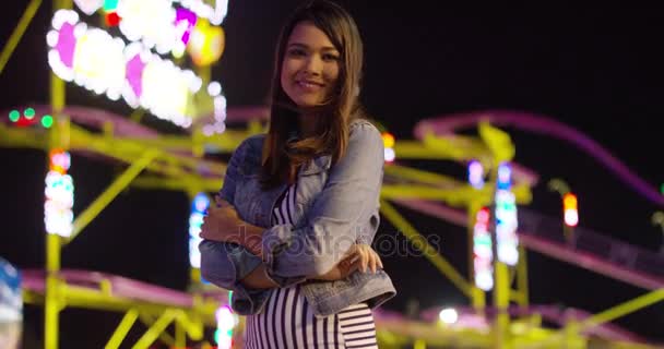 Vivacious young woman at an evening funfair — Stock Video