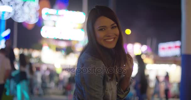 Hermosa mujer en el parque de atracciones durante la noche — Vídeo de stock